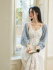 Female guest on a dating show wearing a French-style white sundress pure and innocent made of cotton with embroidery